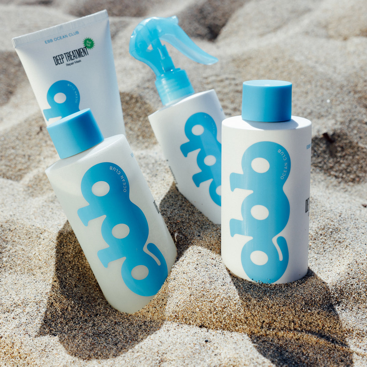 Ebb Ocean Club products sitting in the sand